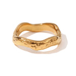 Solo product image of the Wave ring in shiny gold, capturing its textured wave-like form.