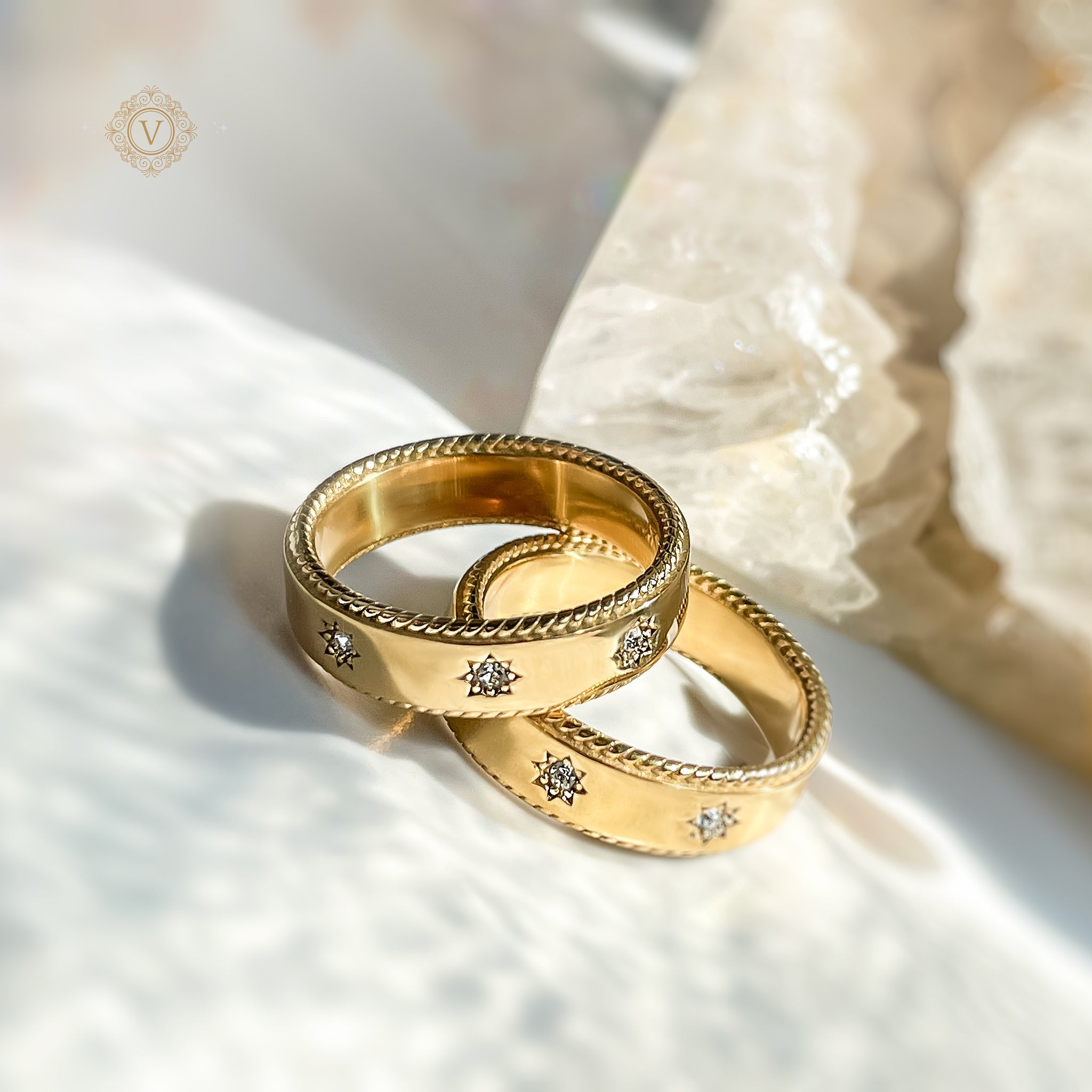 Golden stacking rings with engraved star motifs – Avyrona Sacred Circles collection.