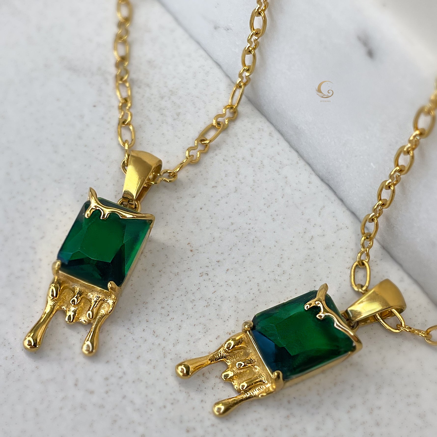  Artistic close-up showcasing intricate honey drip details and vibrant emerald crystal pendant of Mila necklace.