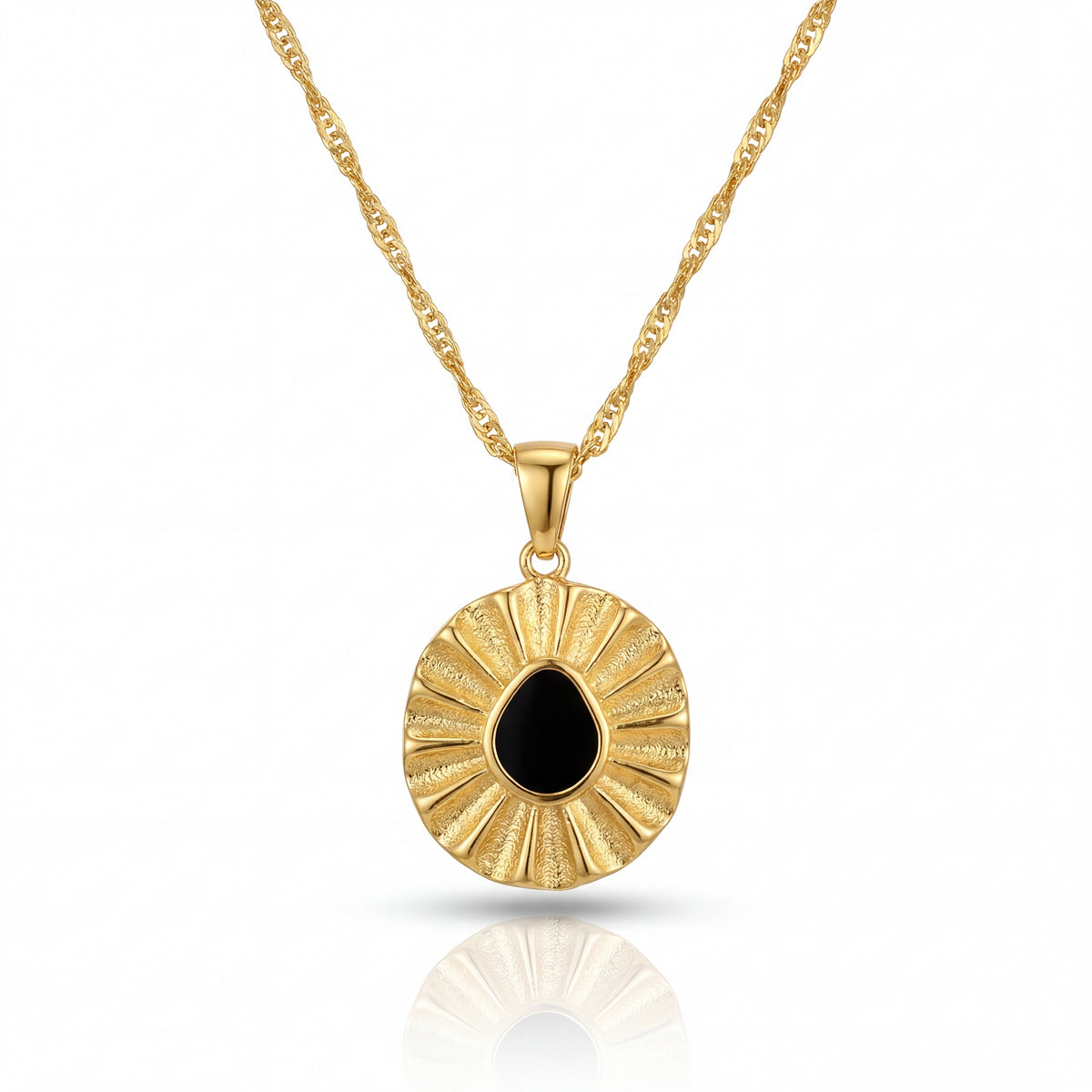 Gold necklace with a round pendant featuring a black stone on a white background