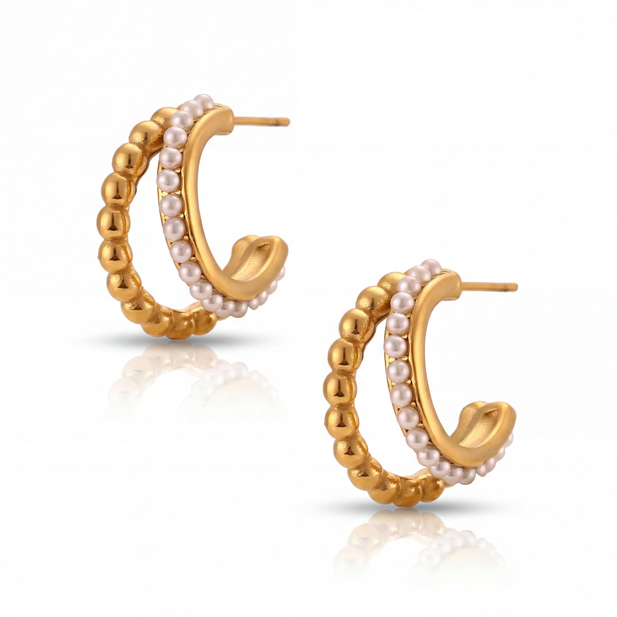 Gold hoop earrings with pearl accents on a white background