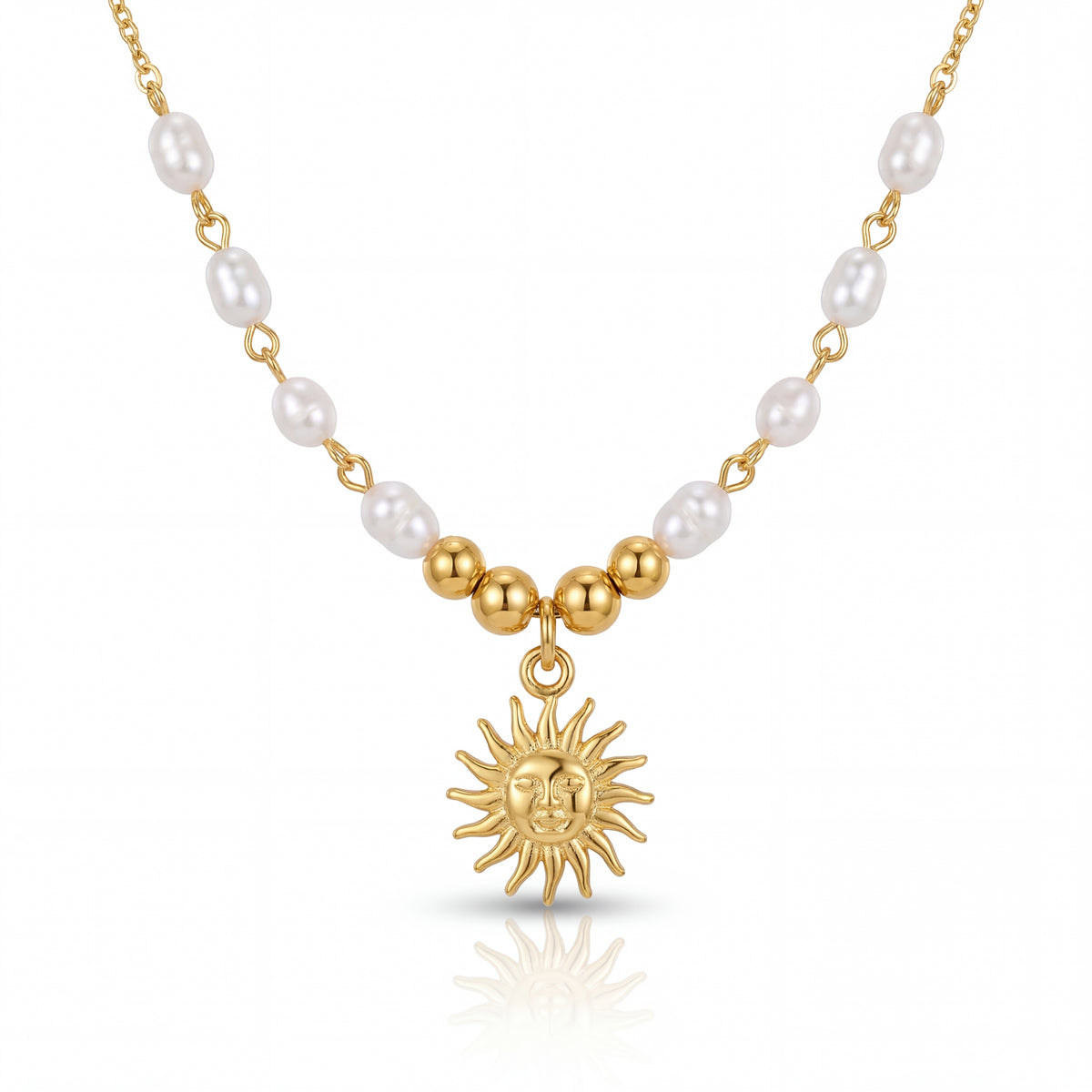 Necklace with gold sun pendant and pearl beads on a white background