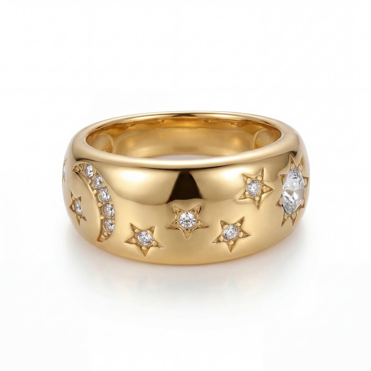 Gold ring with star and moon designs on a white background