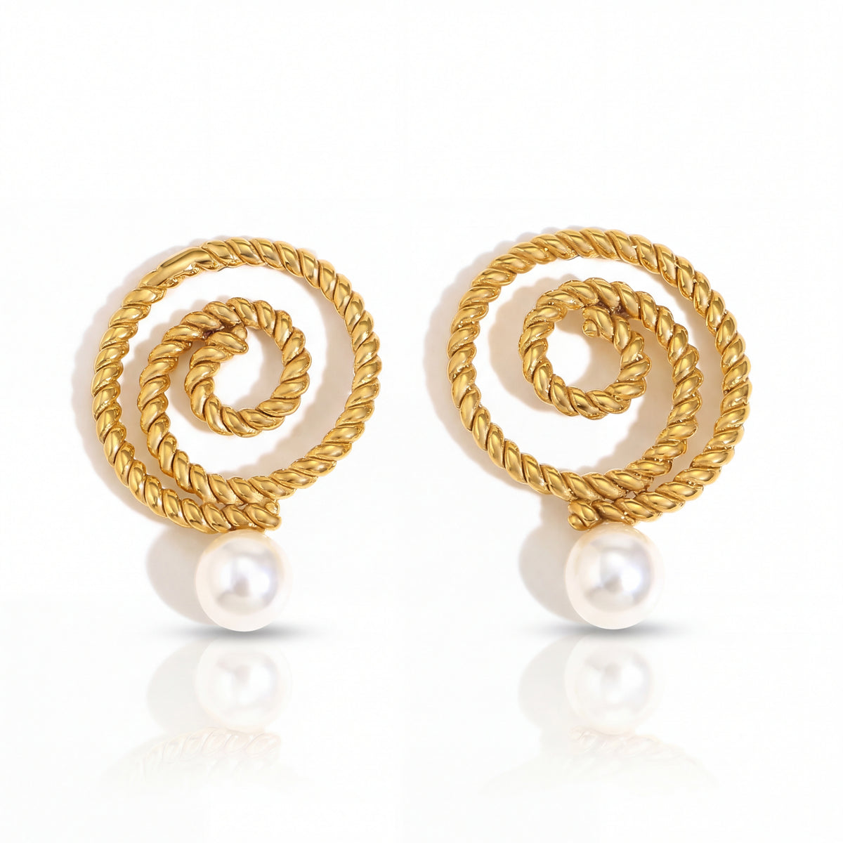 Gold spiral earrings with pearls on a white background