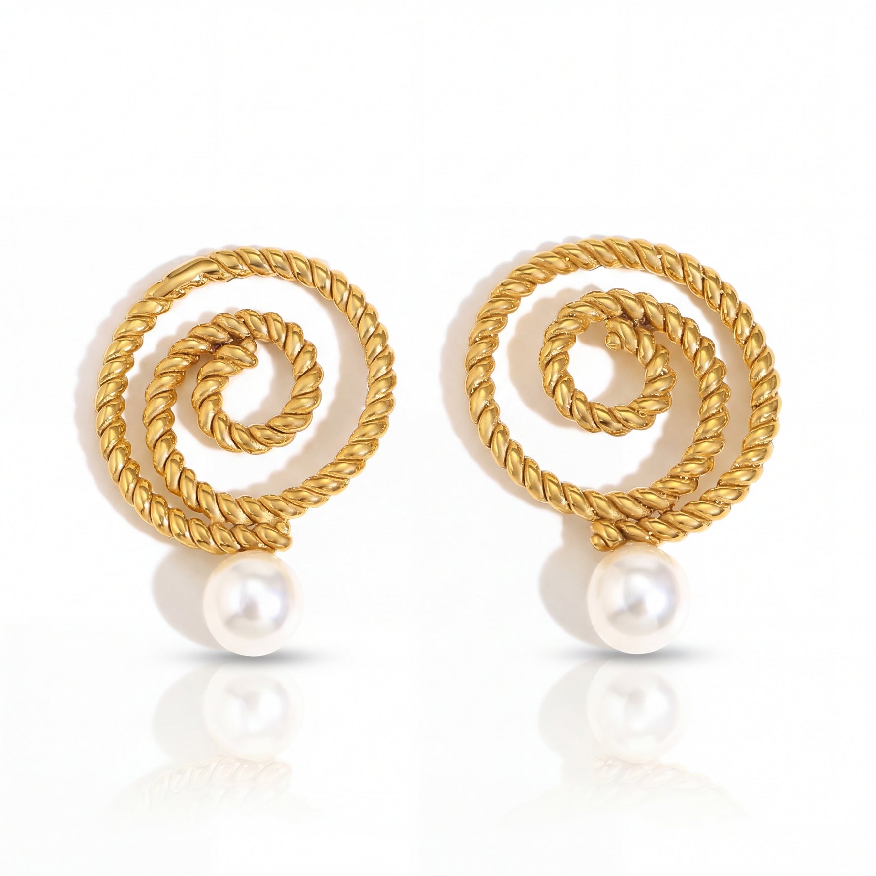 Gold spiral earrings with pearls on a white background
