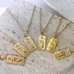 Gold necklaces with pendant designs on a textured surface