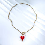 Overhead view of necklace forming a loose circle, highlighting chain texture and pendant