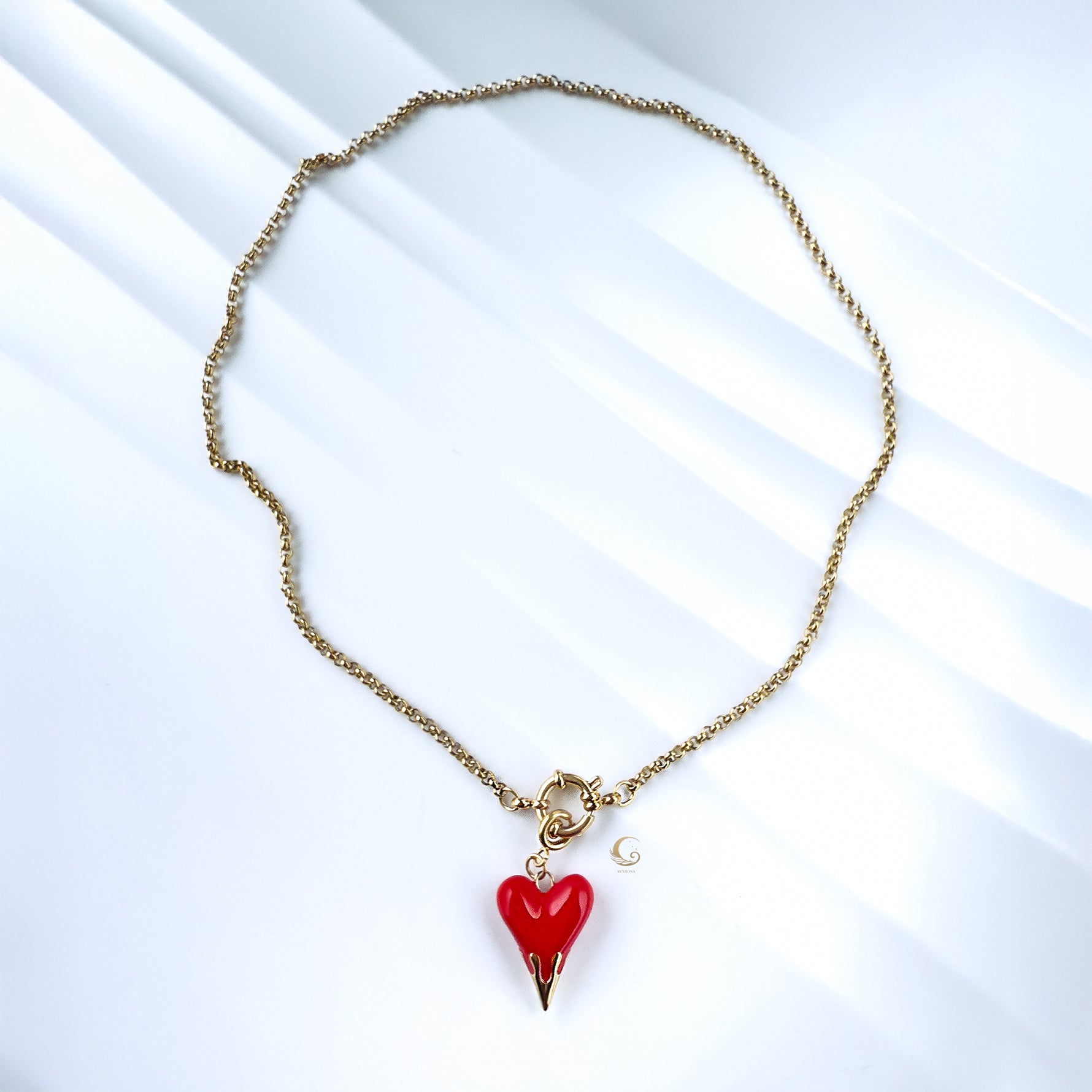 Overhead view of necklace forming a loose circle, highlighting chain texture and pendant