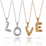 Four gold and silver necklaces with 'LOVE' pendants on a white background