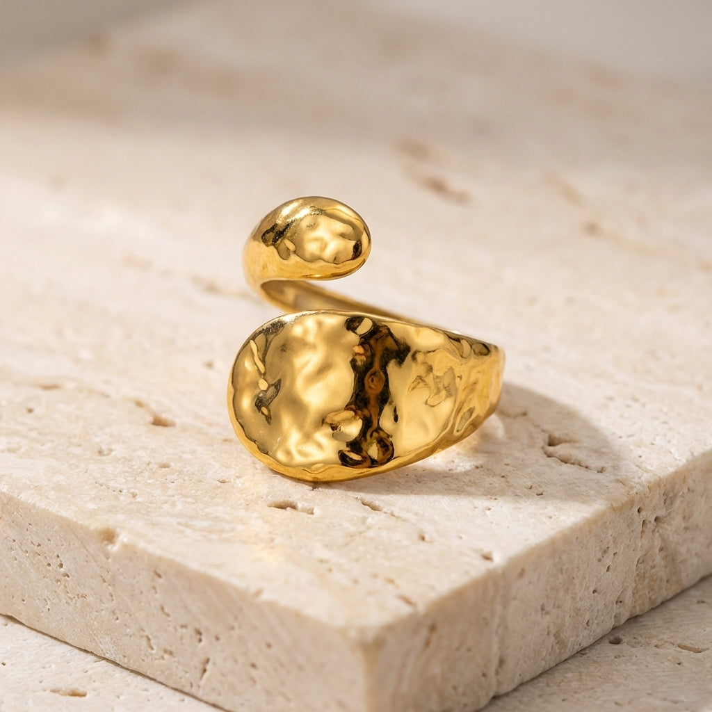 Gold ring on a light stone surface