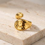 Gold ring on a light stone surface