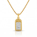 Gold necklace with a pendant featuring a moon design on a white background