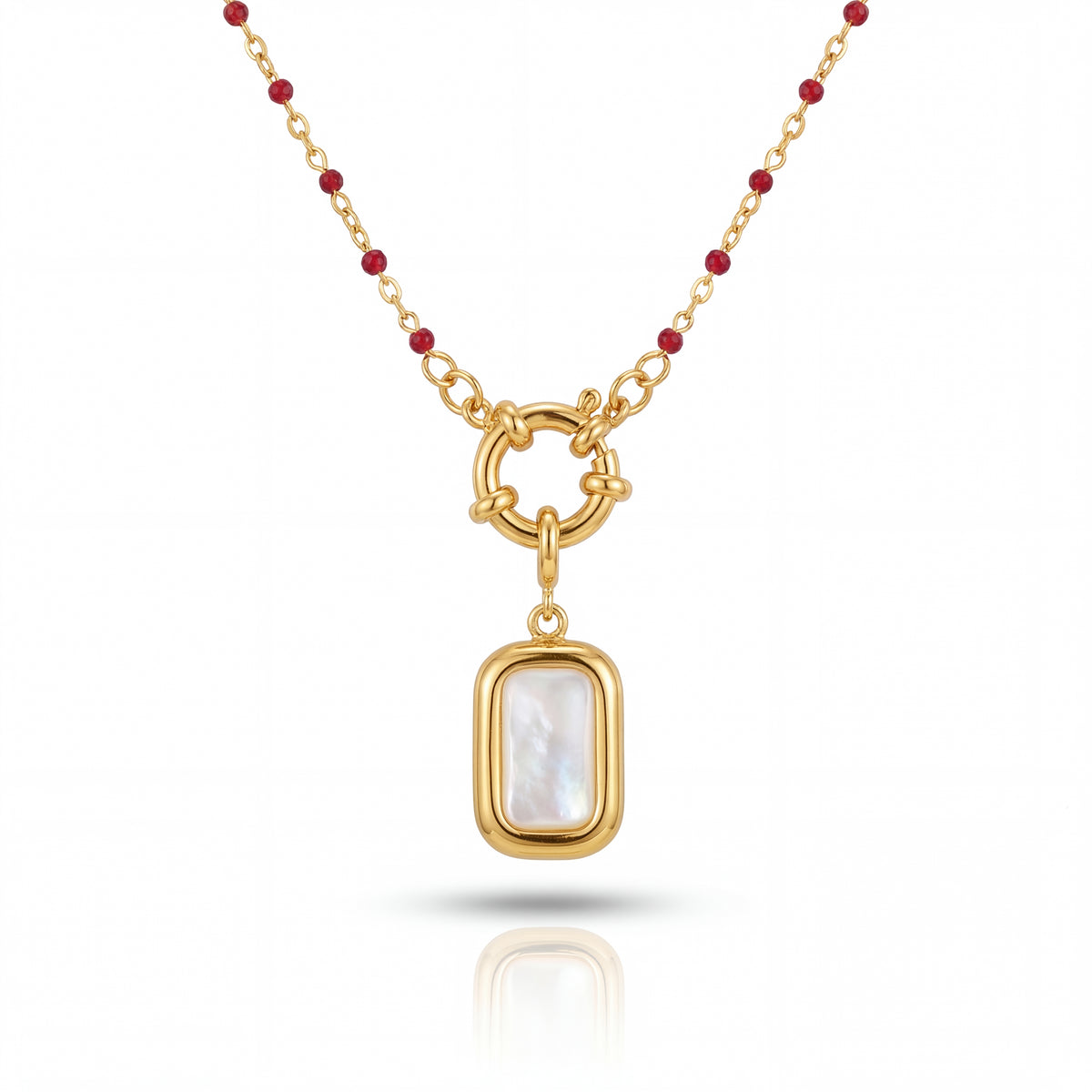 Gold necklace with a pendant featuring a white stone on a white background