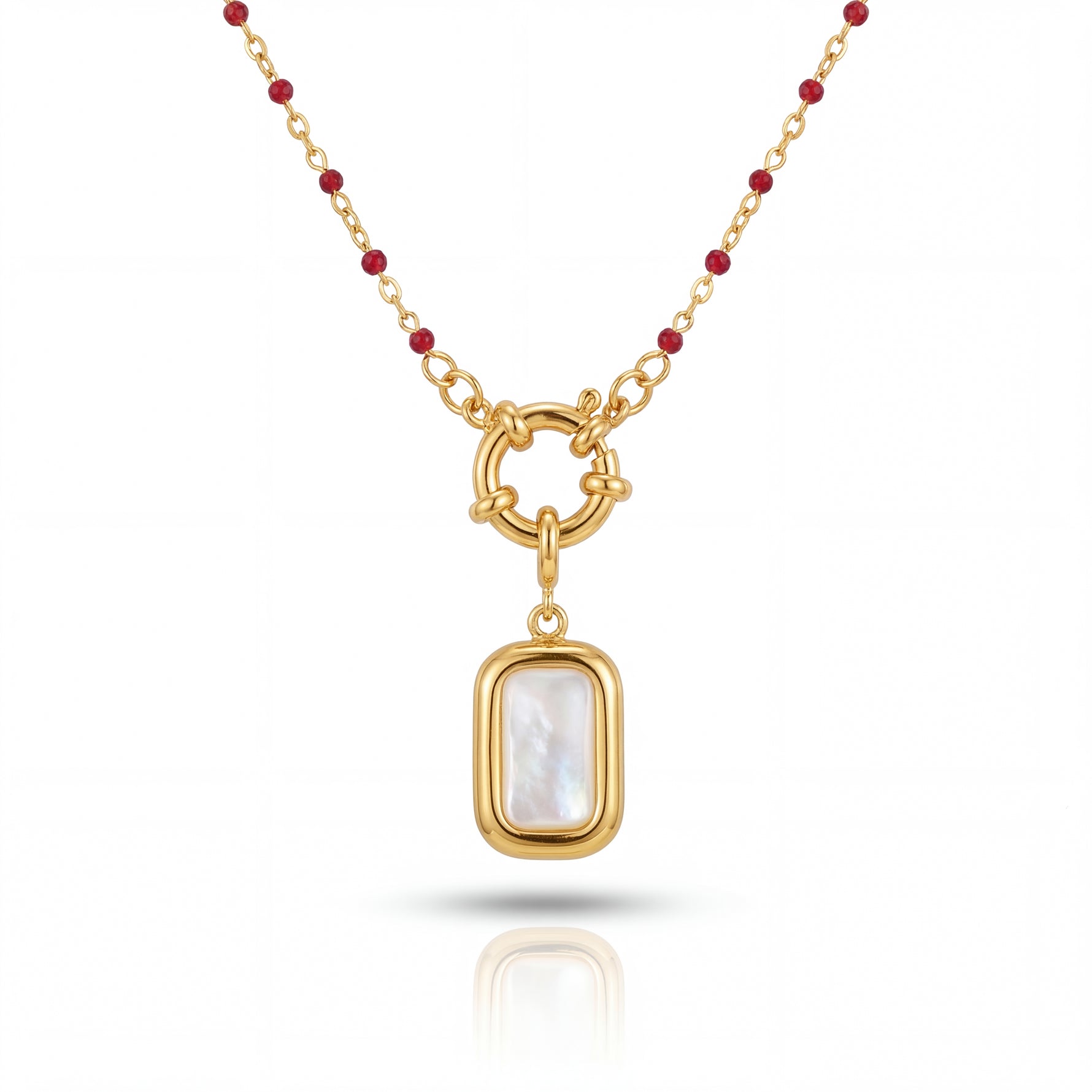 Gold necklace with a pendant featuring a white stone on a white background