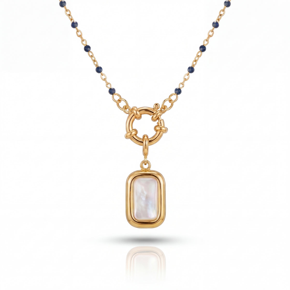 Gold necklace with a pendant featuring a white stone on a white background