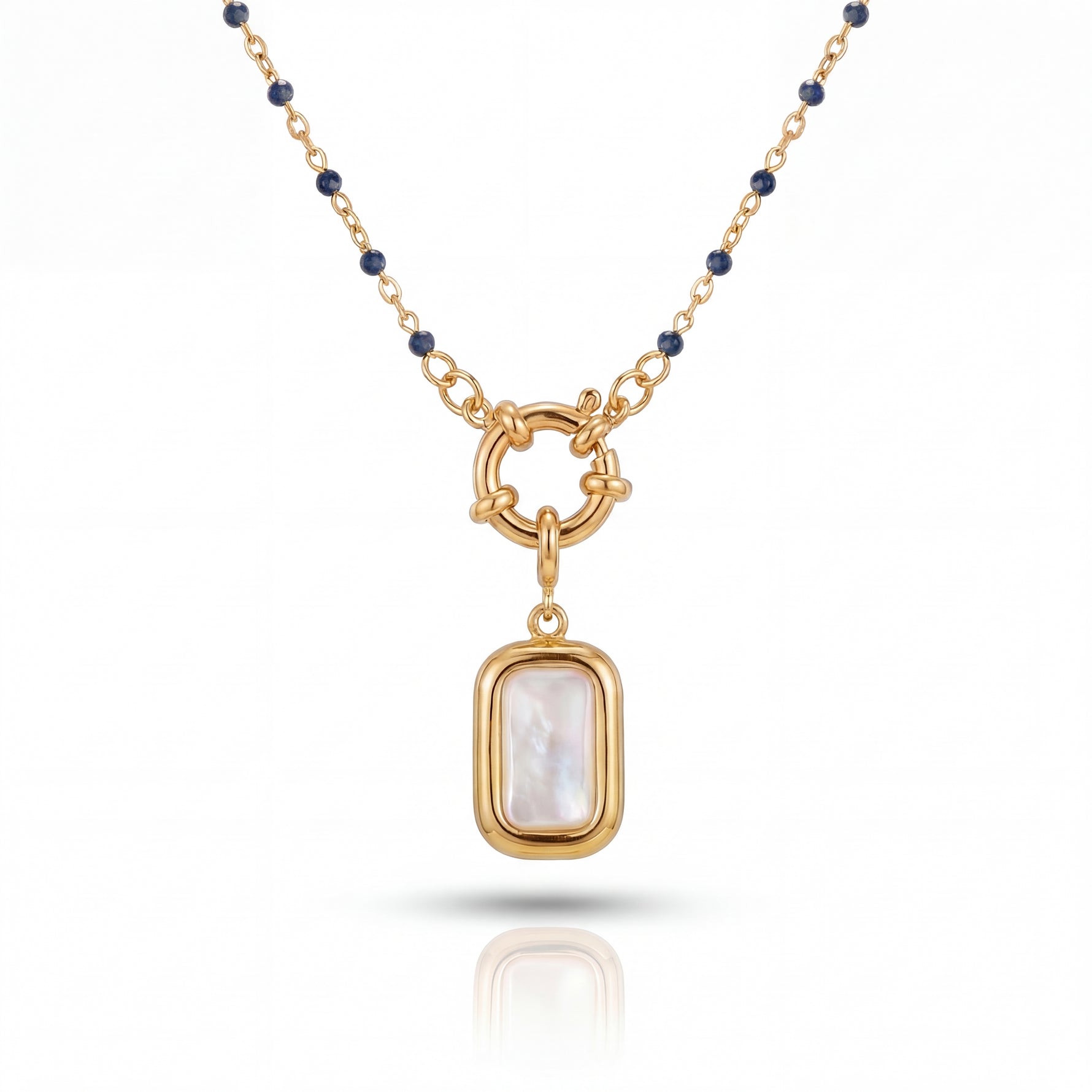 Gold necklace with a pendant featuring a white stone on a white background
