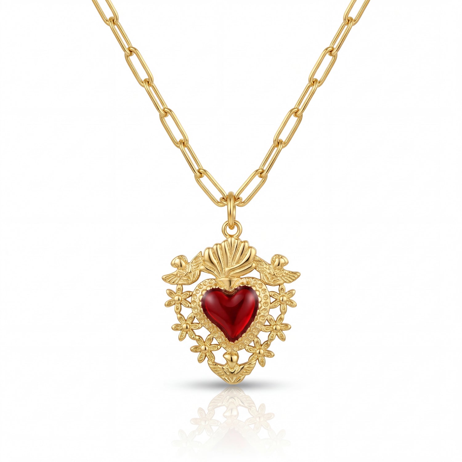 Gold necklace with a red heart pendant on a white background