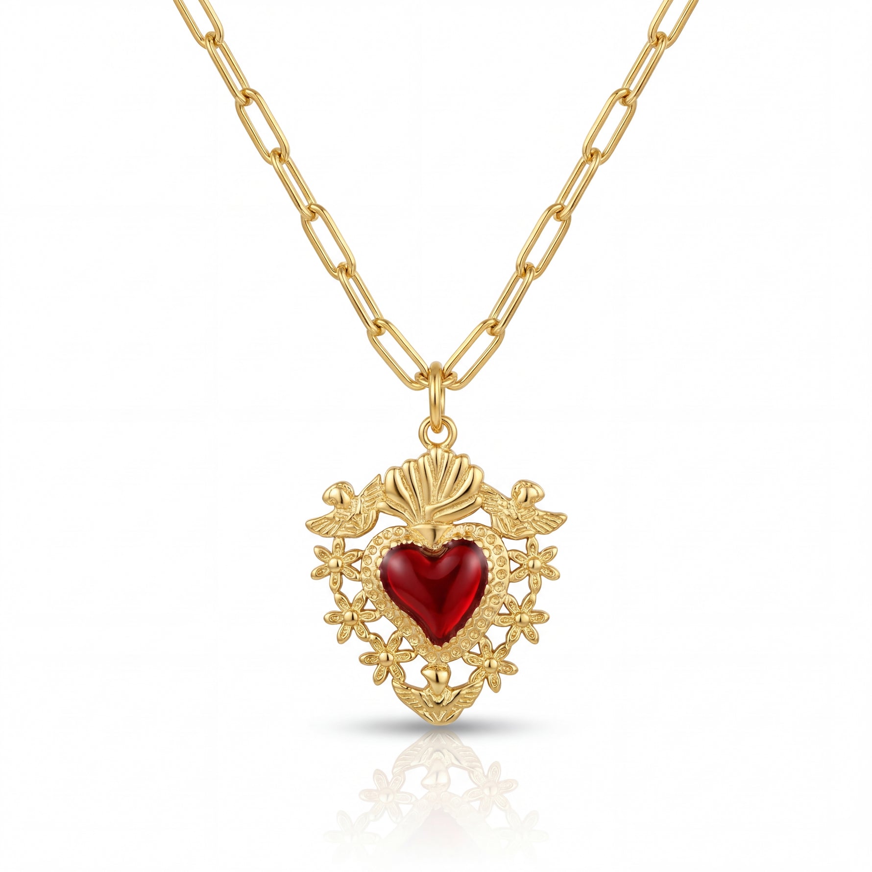 Gold necklace with a red heart pendant on a white background
