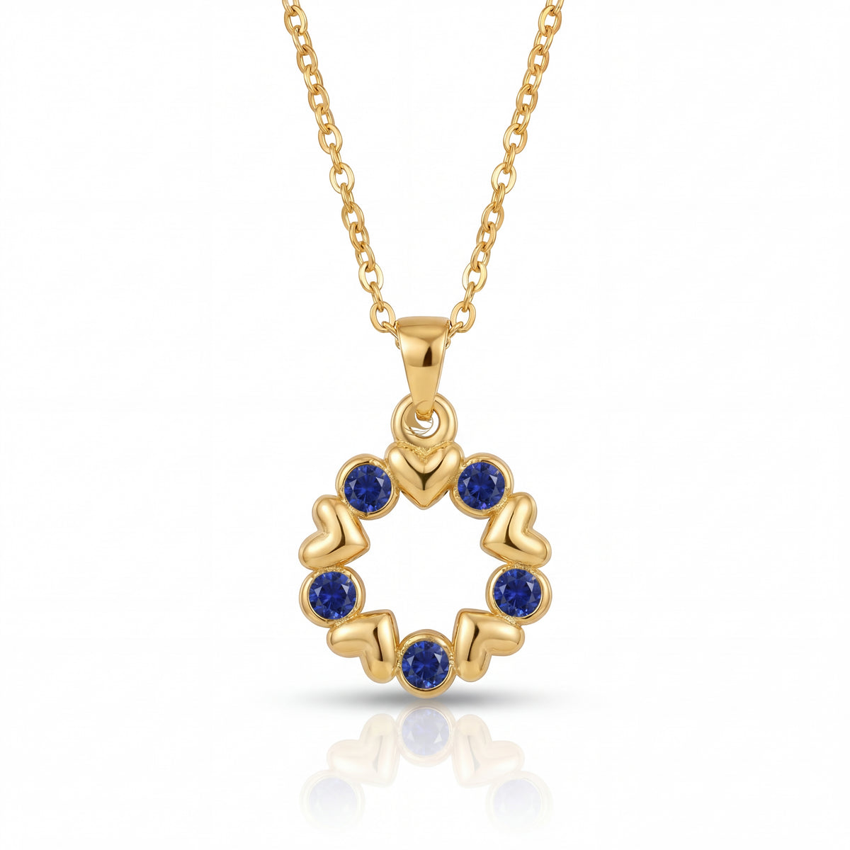 Gold necklace with a circular pendant featuring blue stones on a white background