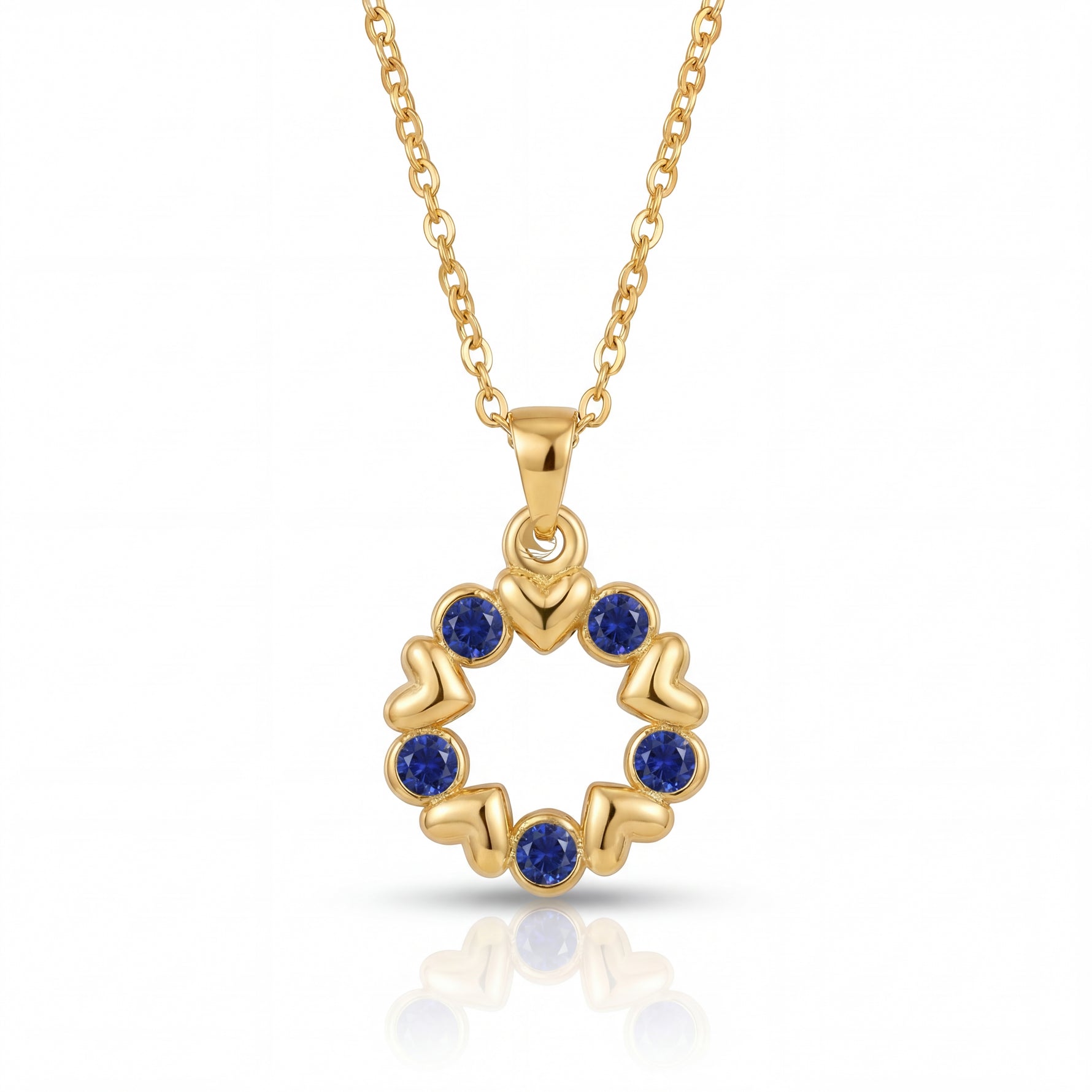 Gold necklace with a circular pendant featuring blue stones on a white background