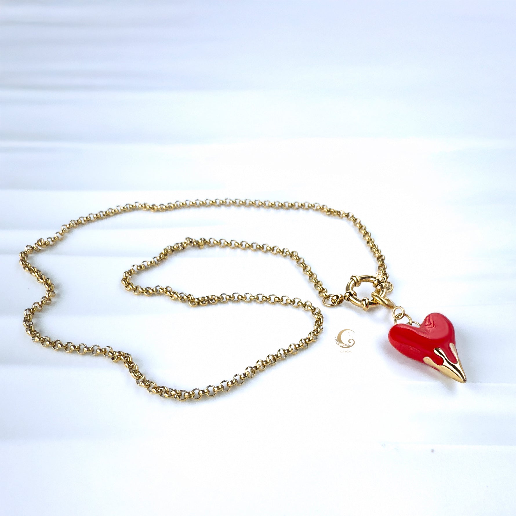 Full necklace layout showing rolo chain and heart pendant on textured background