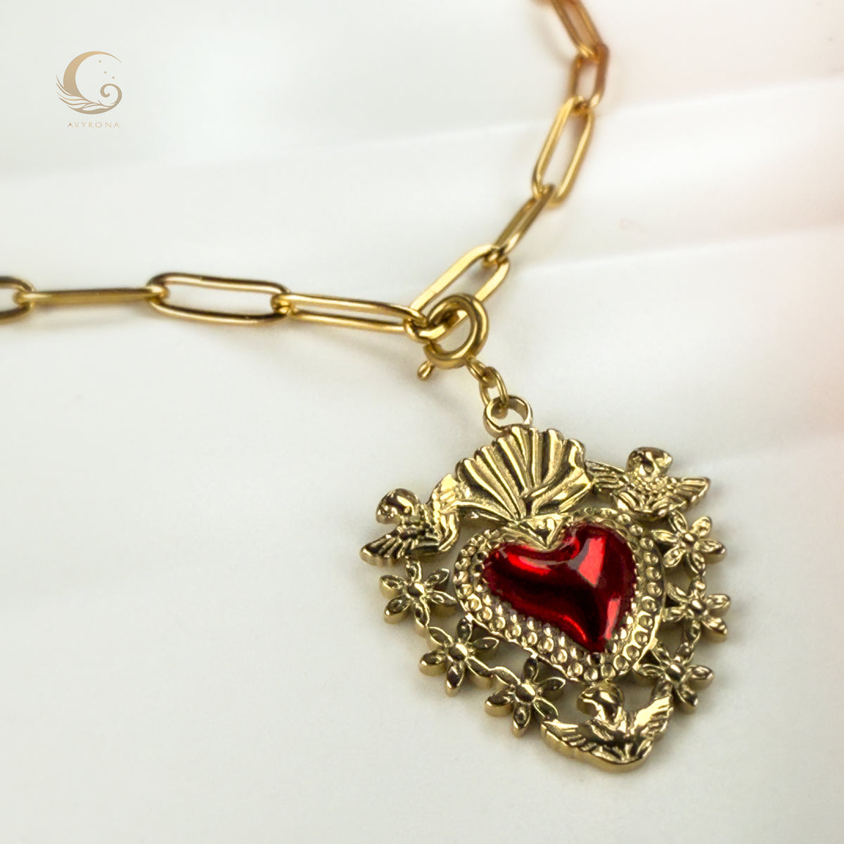 Detailed view of gold Sacred Heart pendant with vivid red enamel and floral accents on Amara necklace.