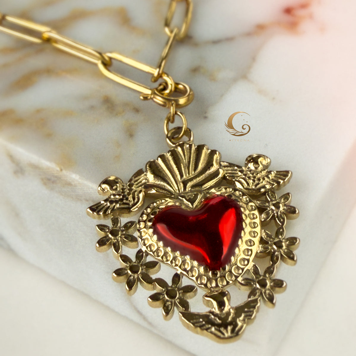 Zoomed-in shot of ornate Sacred Heart pendant with dove and flower details.