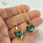 Necklaces shown in hand, highlighting the size of the heart pendants and their glow