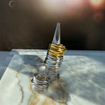 Display of Branch Rings on a clear ring stand, with light casting gentle shadows to emphasize the textured finish.