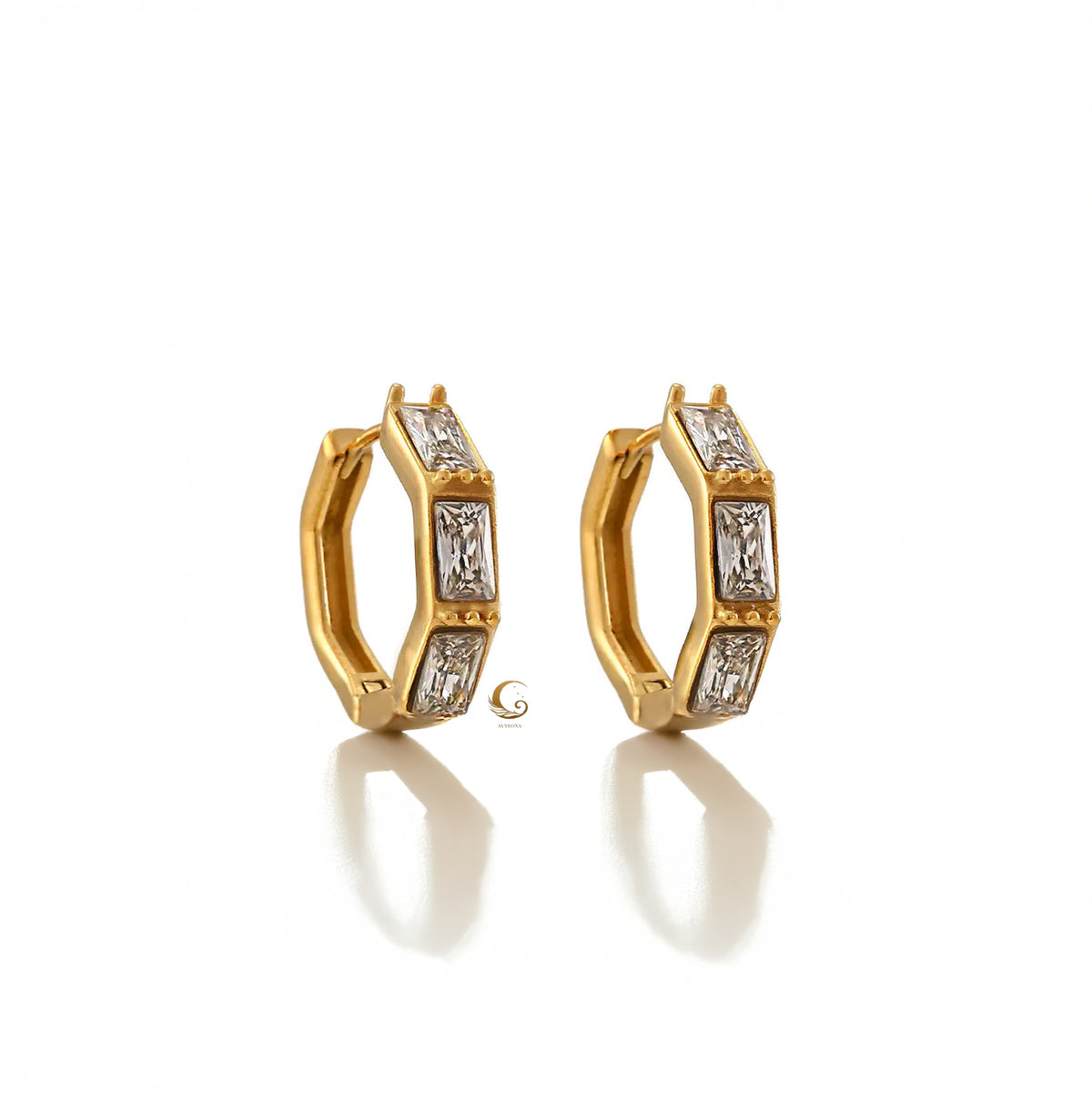 Pair of Camila earrings in gold finish, featuring sparkling clear cubic zirconia stones in a bold hexagonal hoop shape