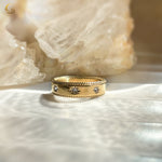 Celestial ring styled on hand with soft focus