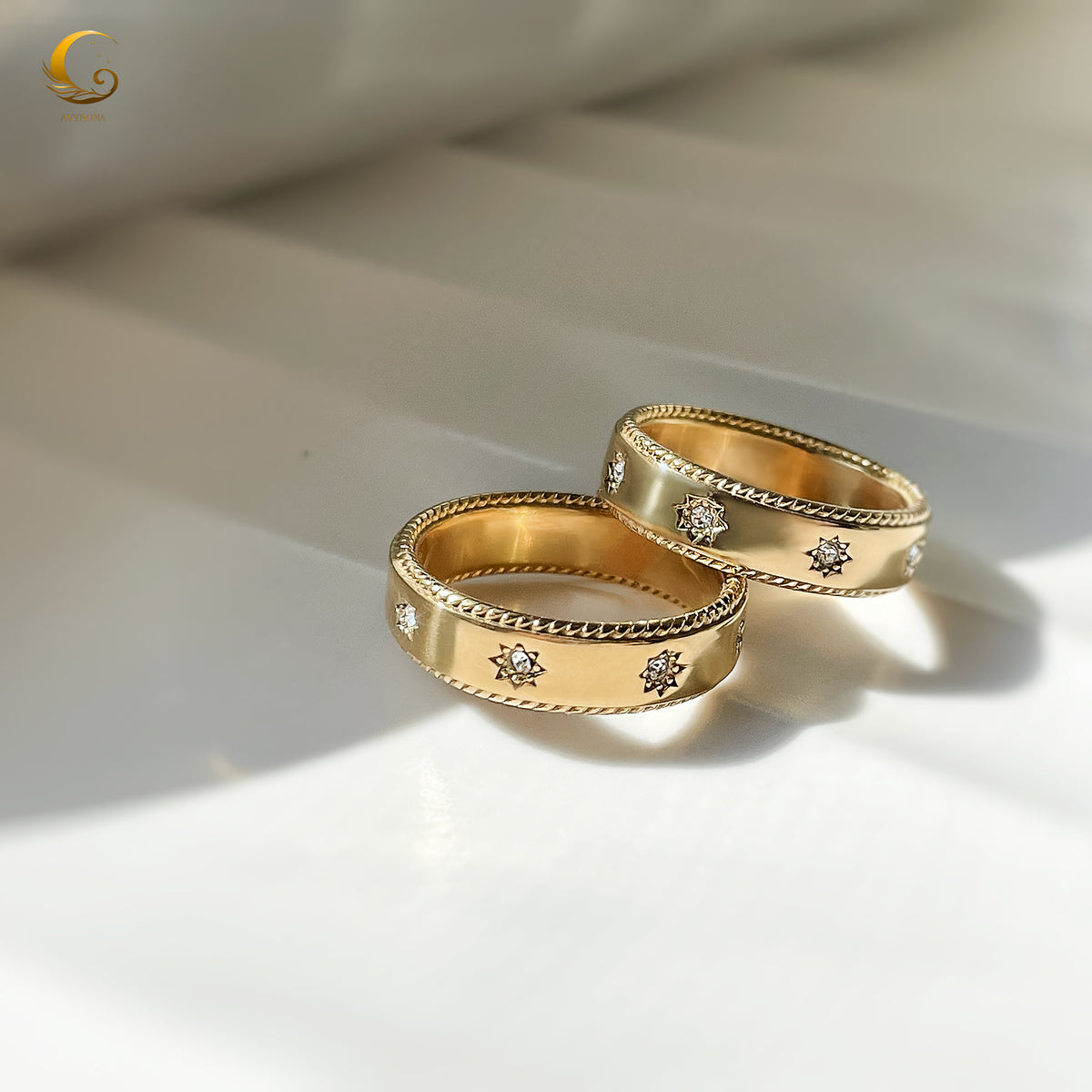 Two celestial star rings displayed on white surface