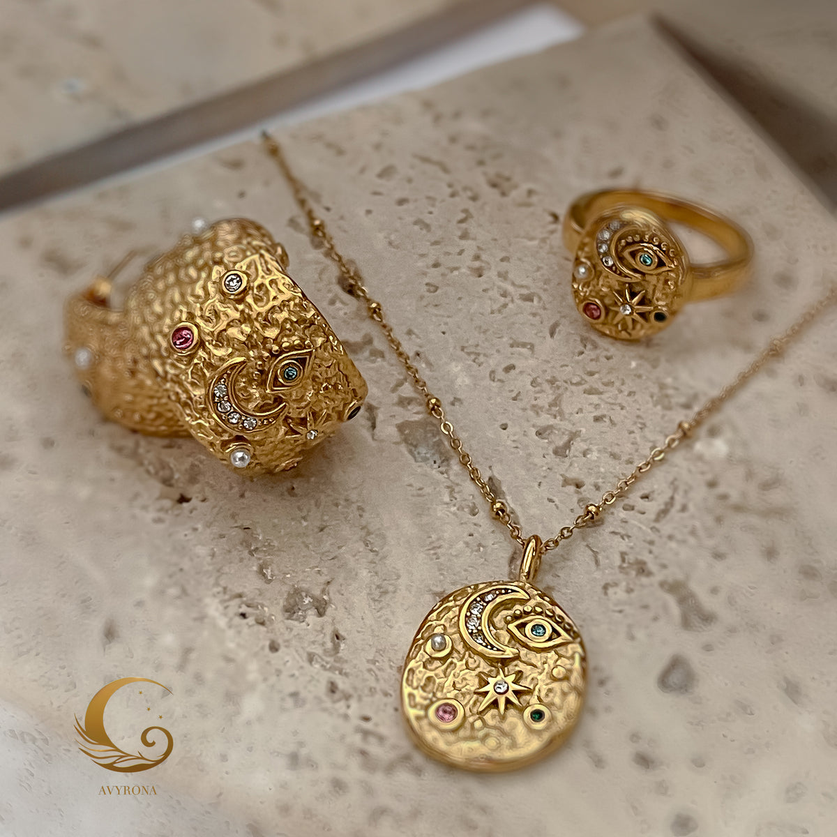 Elara celestial necklace displayed with matching ring and cuff from the same jewelry collection