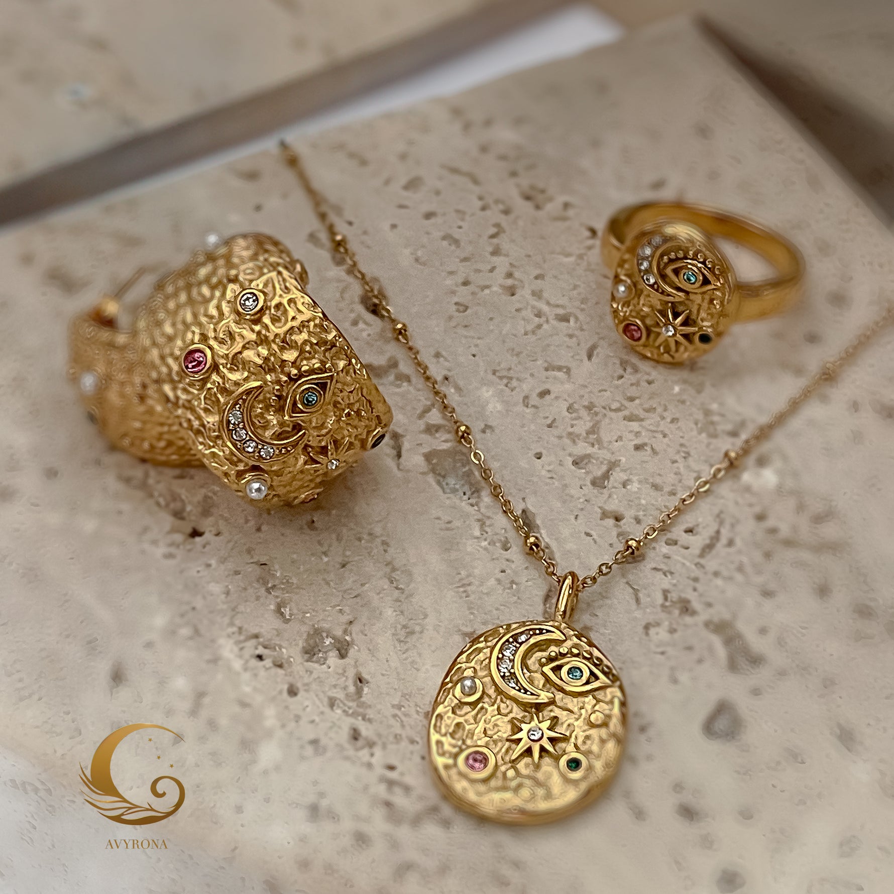 Elara celestial necklace displayed with matching ring and cuff from the same jewelry collection