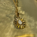 Detailed shot of the Elara white enamel flower necklace showing the soft glossy enamel and gold-plated petals.