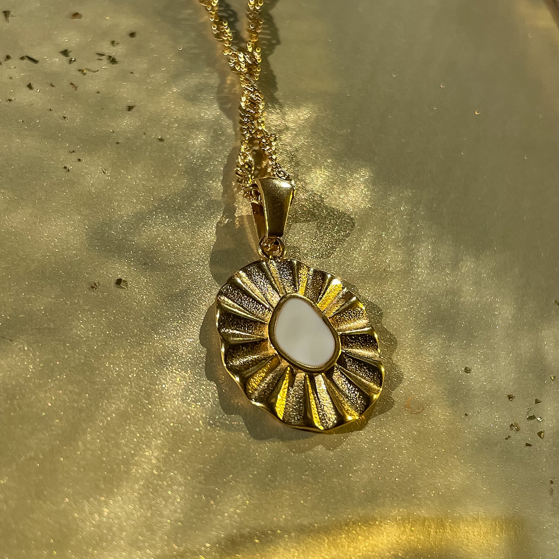 Detailed shot of the Elara white enamel flower necklace showing the soft glossy enamel and gold-plated petals.