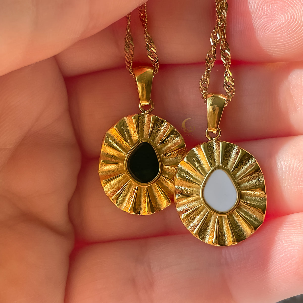 Close-up of the Elara white enamel flower necklace from Avyrona Earth Collection, shown in hand for size reference and detail.