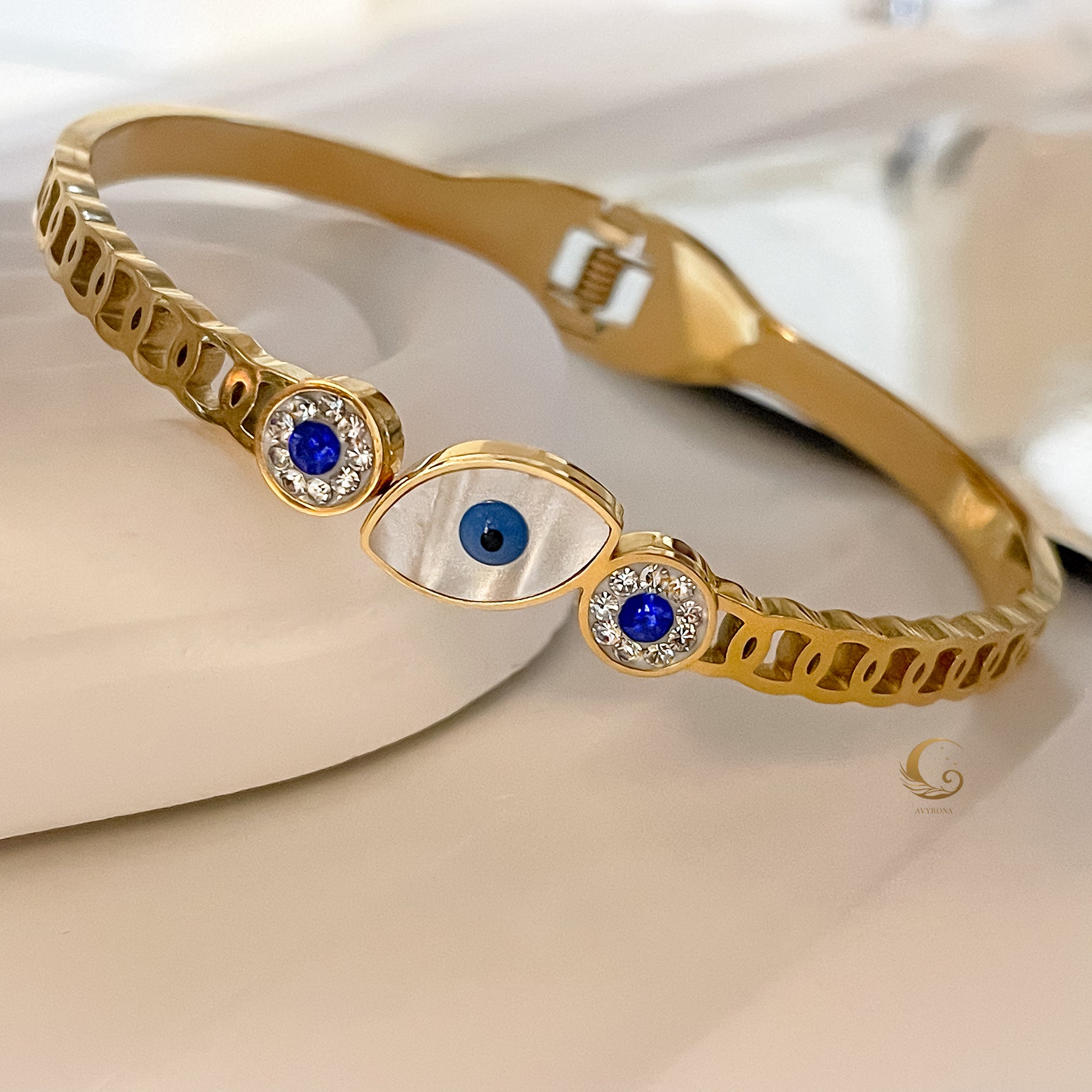 Elina bangle bracelet with Evil Eye symbolism on table