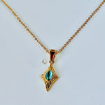 Guardian Eye necklace featuring a blue cat eye stone on a twisted gold rope chain, photographed on a light plain background.