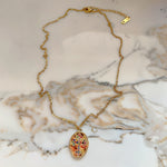 Full Isadora necklace with clasp displayed on marble, highlighting elegant chain and pendant.