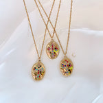 Three Isadora necklaces laid out together, showing subtle variations in stone placement.