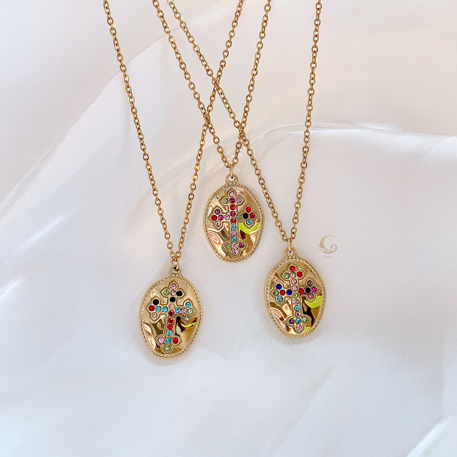 Three Isadora necklaces laid out together, showing subtle variations in stone placement.