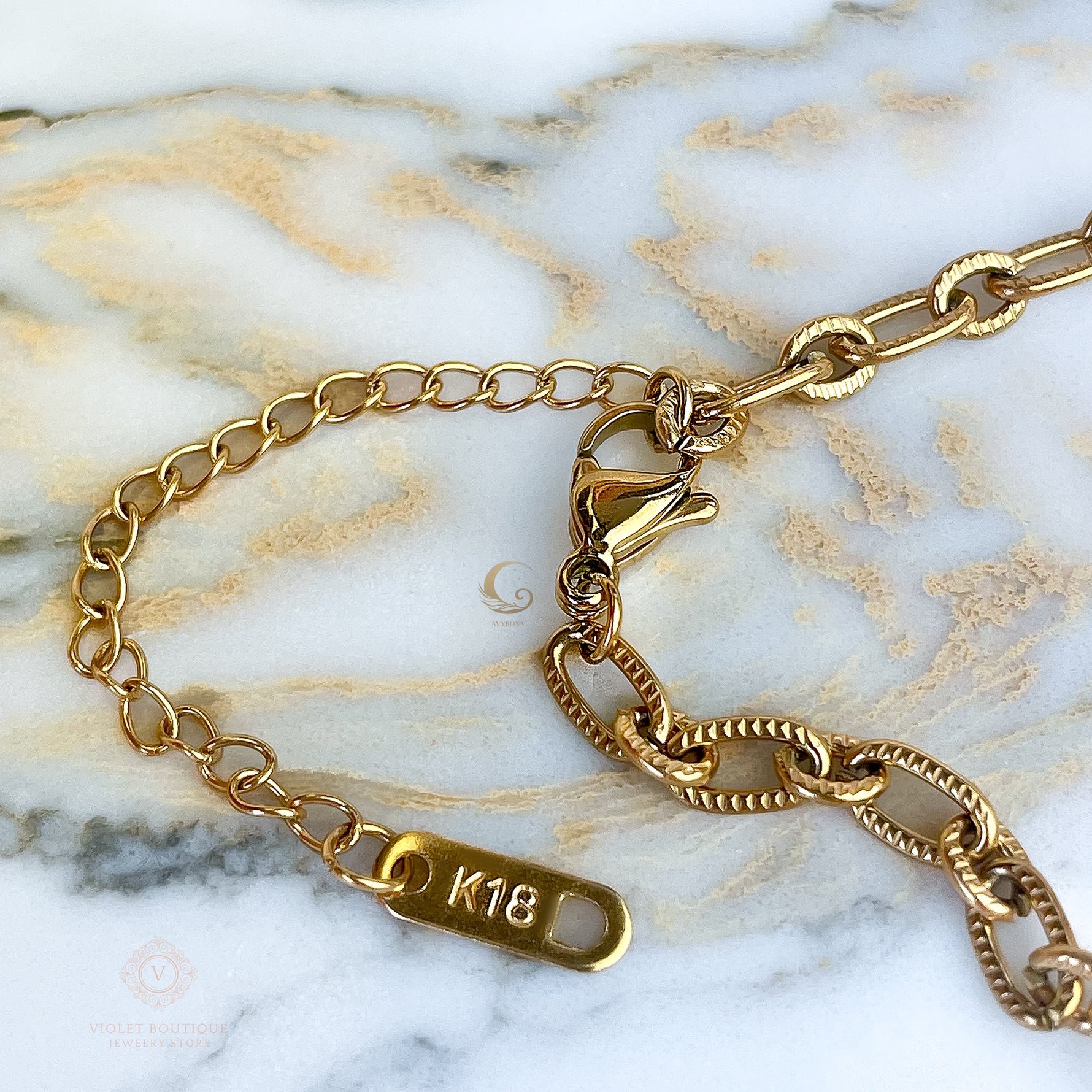 Detail of lobster clasp and extender with K18 tag on the Lyra necklace.