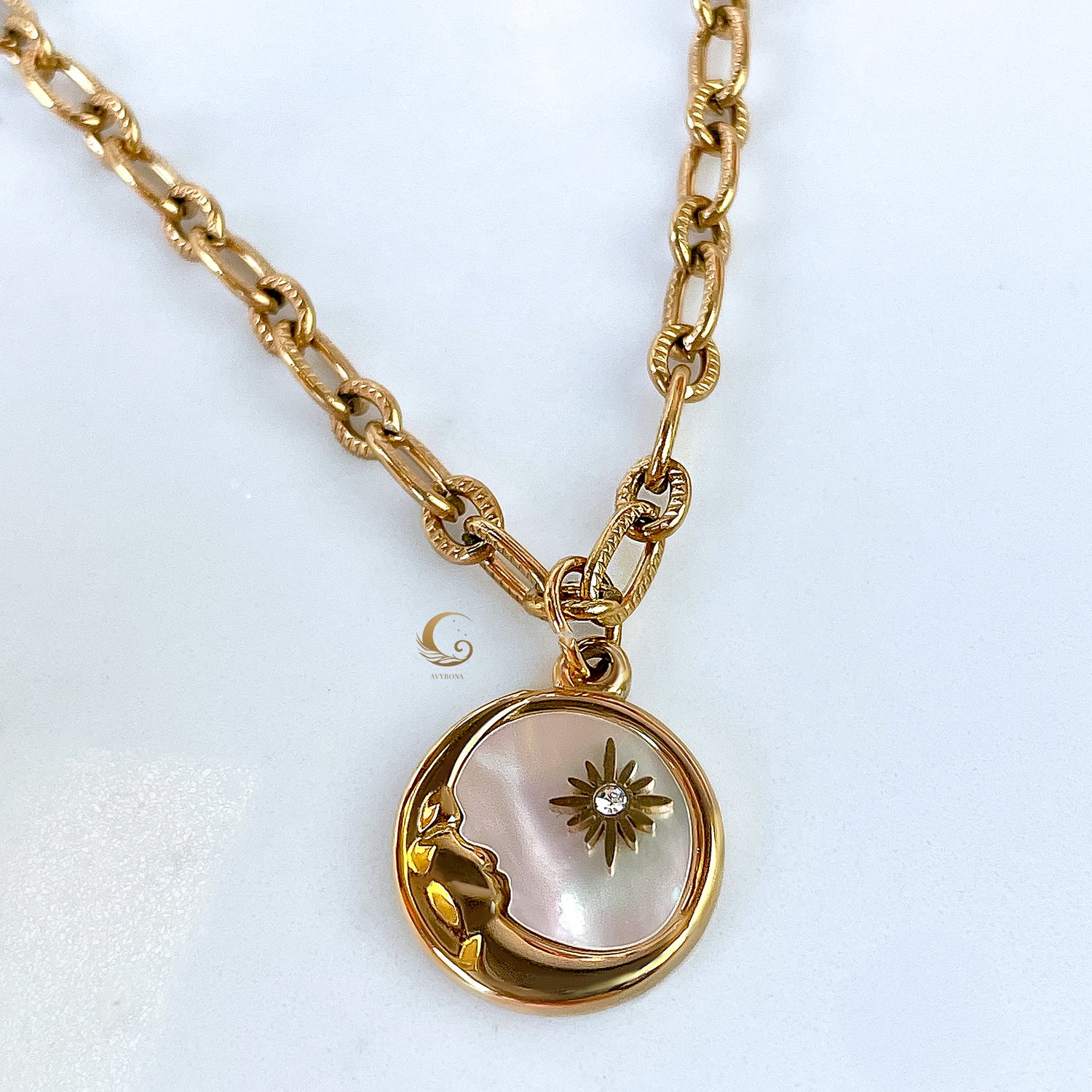 Front view of the celestial pendant hanging from a bold gold chain.