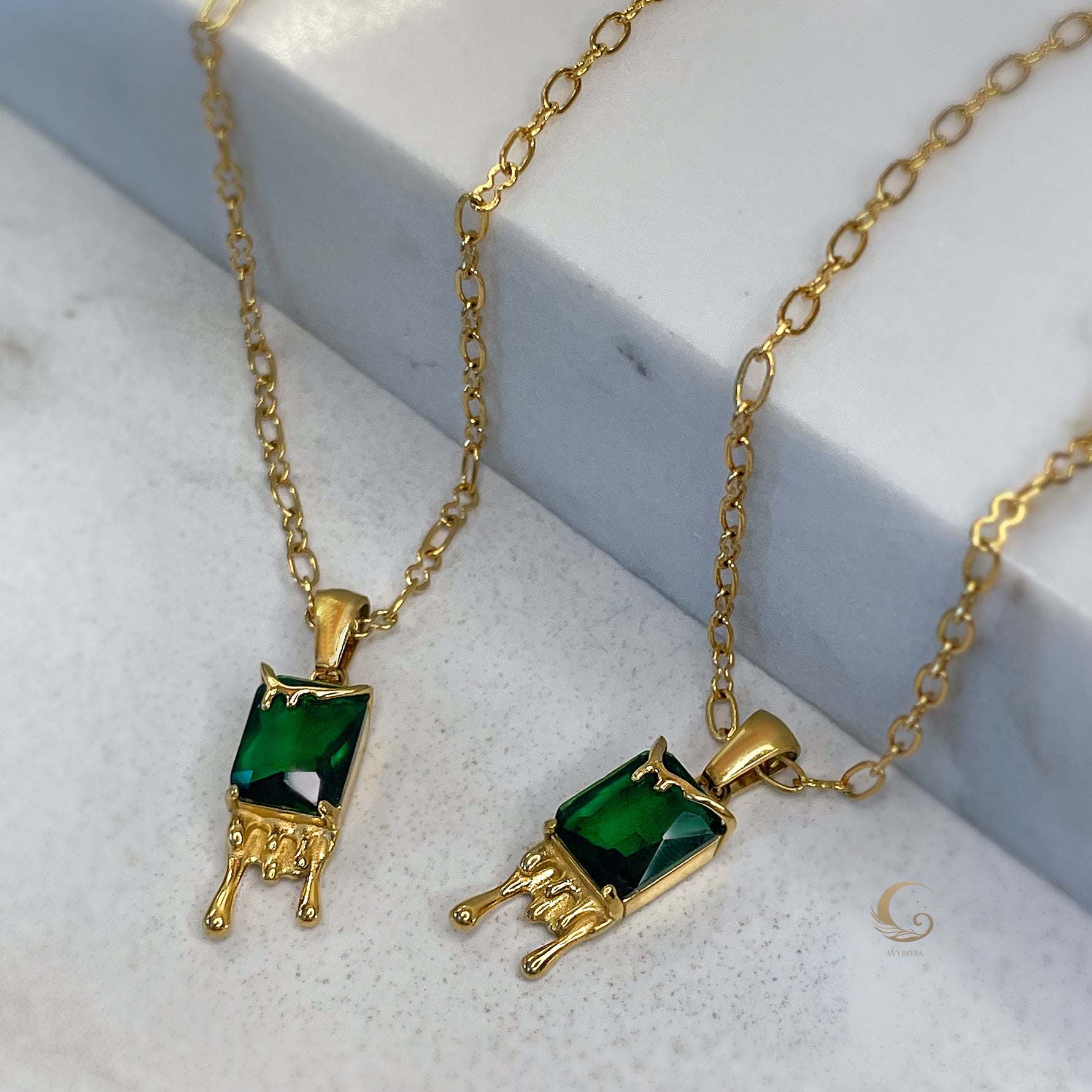 Mila honey drip necklace with deep green crystal on marble, 18K gold-plated pendant, earthy style jewelry by Avyrona.