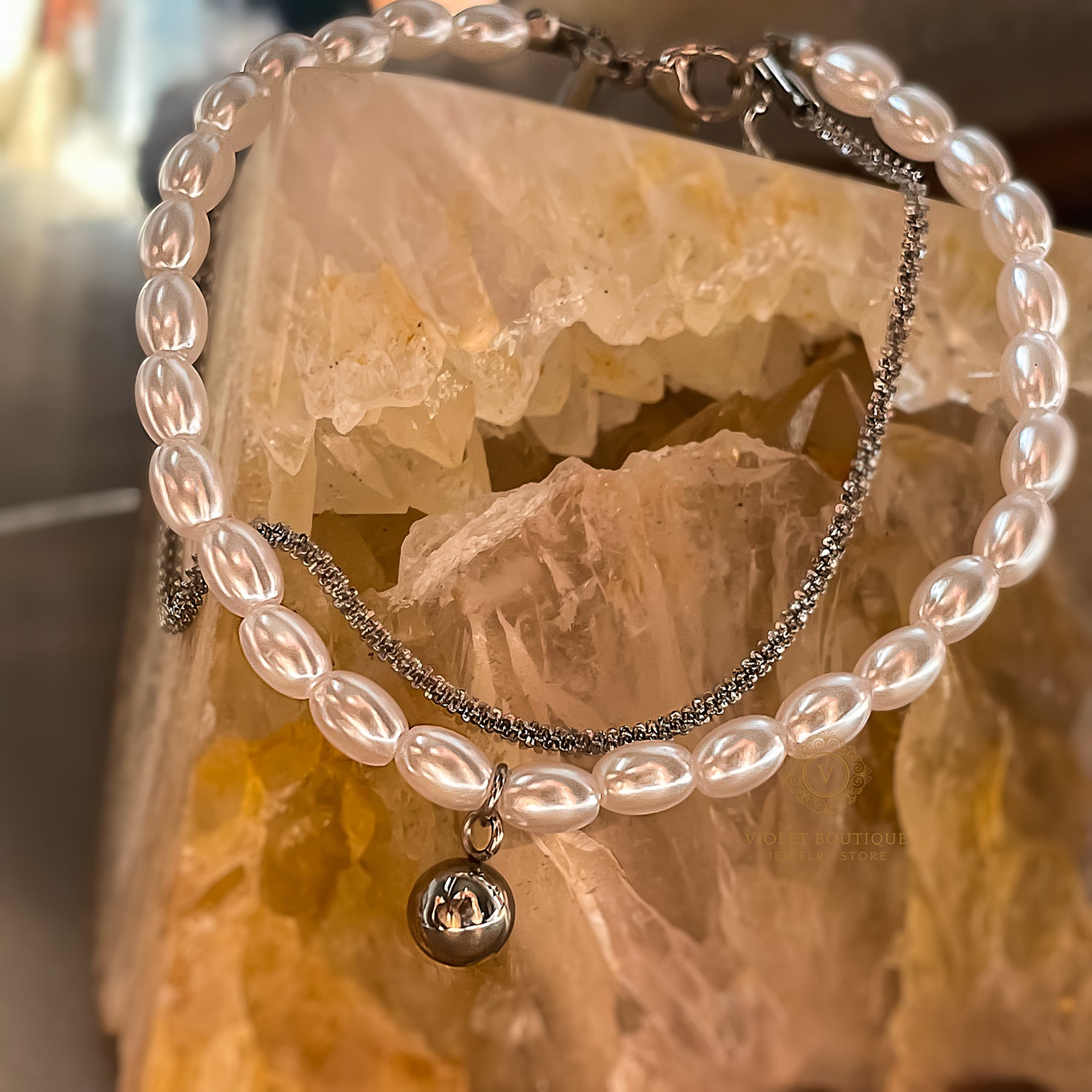 Mimoza double-layered bracelet featuring luminous vegan pearls and stainless steel charm, elegant waterproof jewelry from Avyrona.
