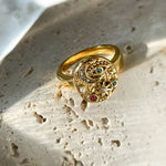 Single Moonlight collection ring with evil eye, moon, and star motifs, sparkling in daylight. 18K gold-plated finish on sturdy stainless steel base.