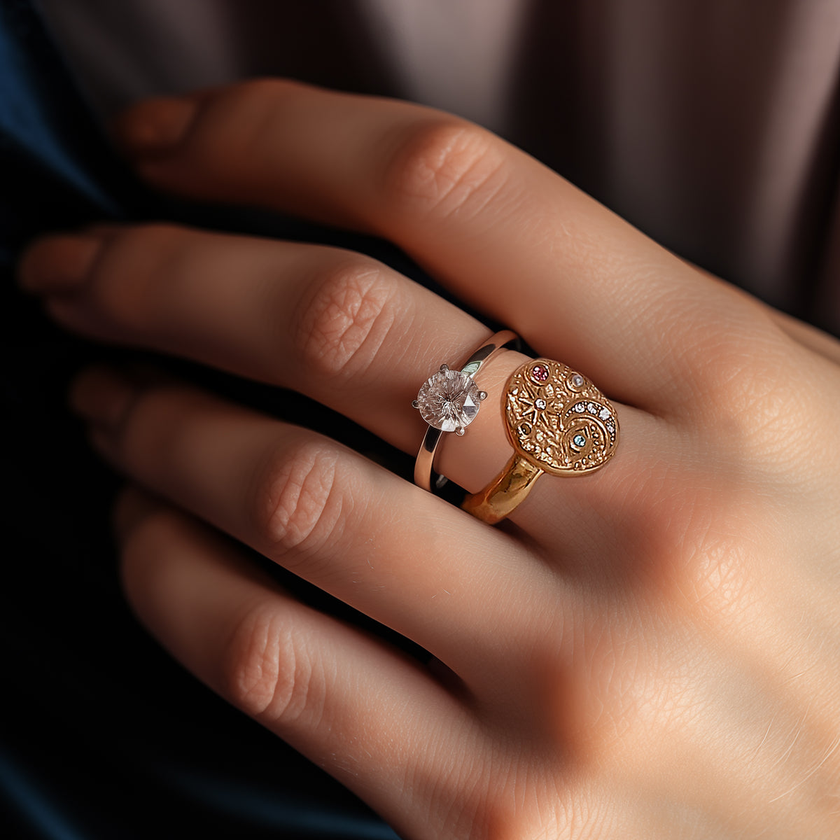 Moonlight celestial ring worn next to a solitaire ring on a hand. Beautiful contrast between sparkle and engraved cosmic symbols.