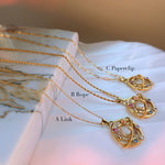 Gold celestial moon necklaces labeled A Link, B Rope, and C Paperclip, displayed on marble stone surface.