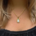 Selara tarot moon necklace in 18K gold plated 316L stainless steel worn on model — celestial pendant with crescent moon and star engraving by Avyrona.